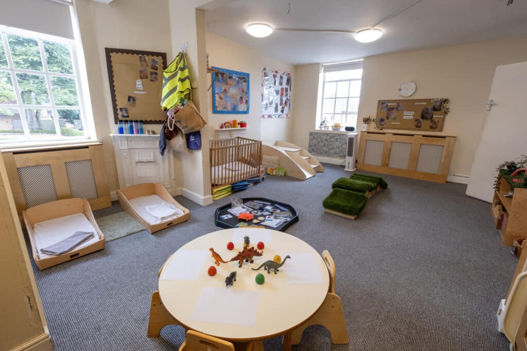 Bright and inviting childcare indoor play area with soft mats, toys, and child-friendly furniture; perfect for early childhood development at Thrive Childcare.
