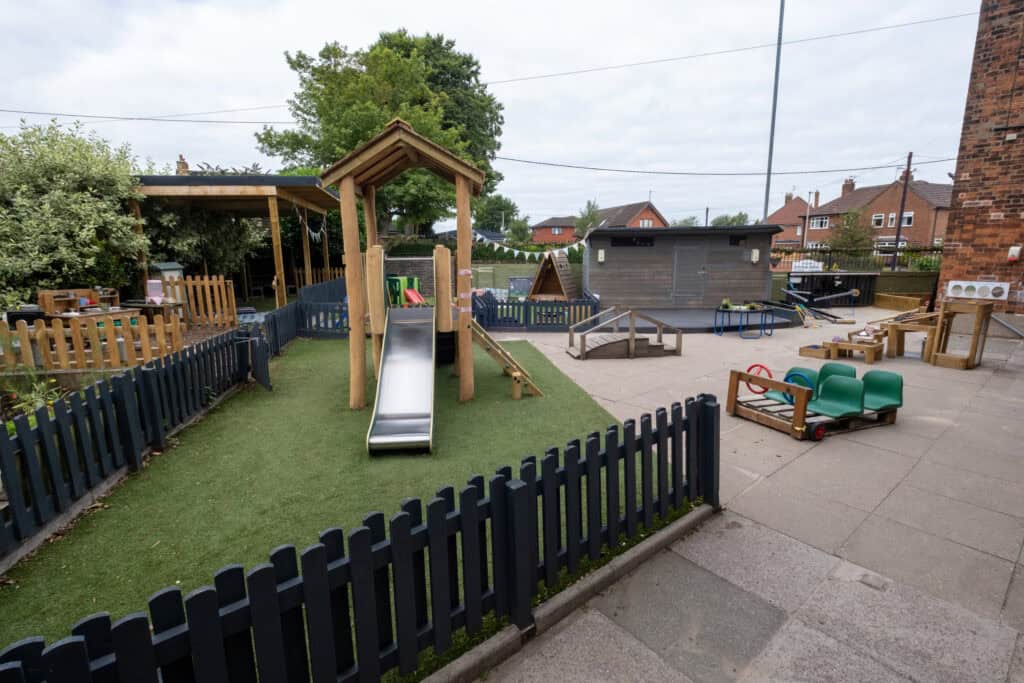 Bright outdoor playground at Thrive Childcare with slides, climbing frames, and sensory play areas designed for early childhood development and fun.