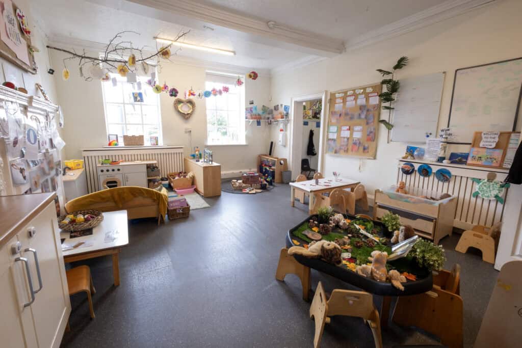 Bright, welcoming Thrive Childcare indoor playroom with children’s toys, learning areas, and colourful decorations promoting early childhood development and safe, engaging environment.