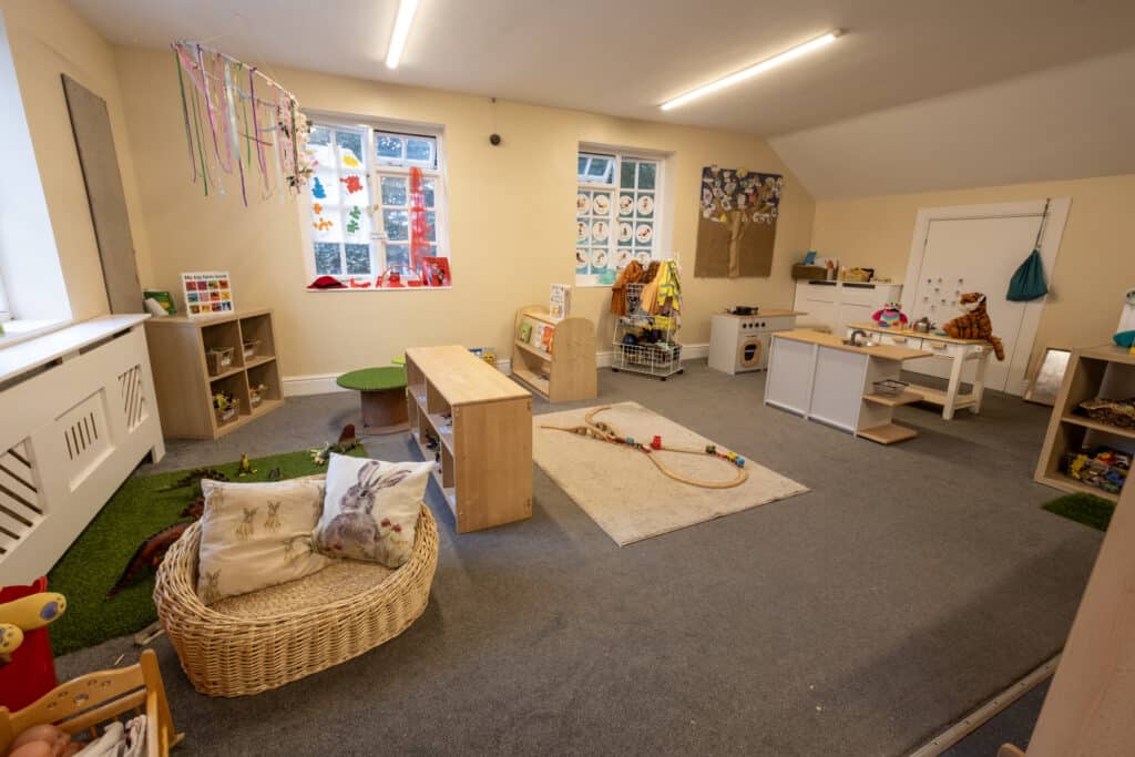 Bright, inviting Thrive Childcare playroom with Montessori-style furniture and toys for early childhood development, fostering creativity, learning, and fun in a safe, nurturing environment.