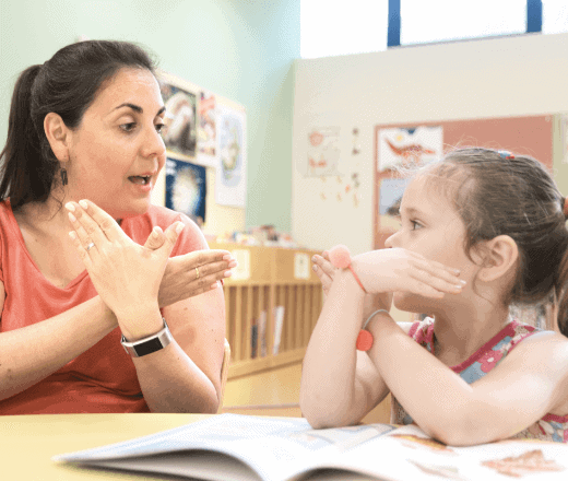1. Experienced childcare educator engaging with young girl in a classroom at Thrive Childcare, promoting early childhood development and learning.