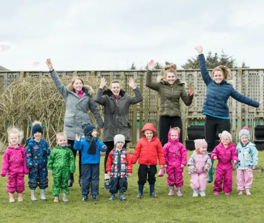 Bright-eyed children and staff enjoying outdoor activities at Thrive Childcare, fostering early childhood development and fun in a safe environment.