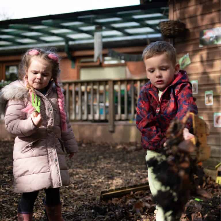 Children playing outdoors at Thrive Childcare, engaging in nature-based learning and exploration. Focused on early childhood development, outdoor play, and nurturing environments for young children.