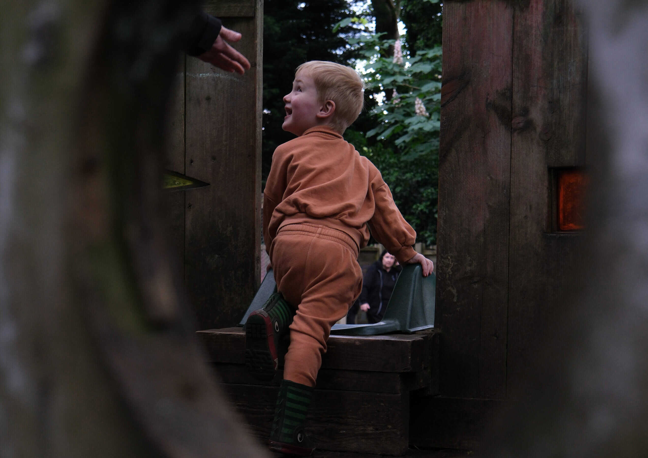 Bright young child enjoying outdoor play at Thrive Childcare, exploring nature and developing social skills in a safe, nurturing environment. Perfect for early childhood development.