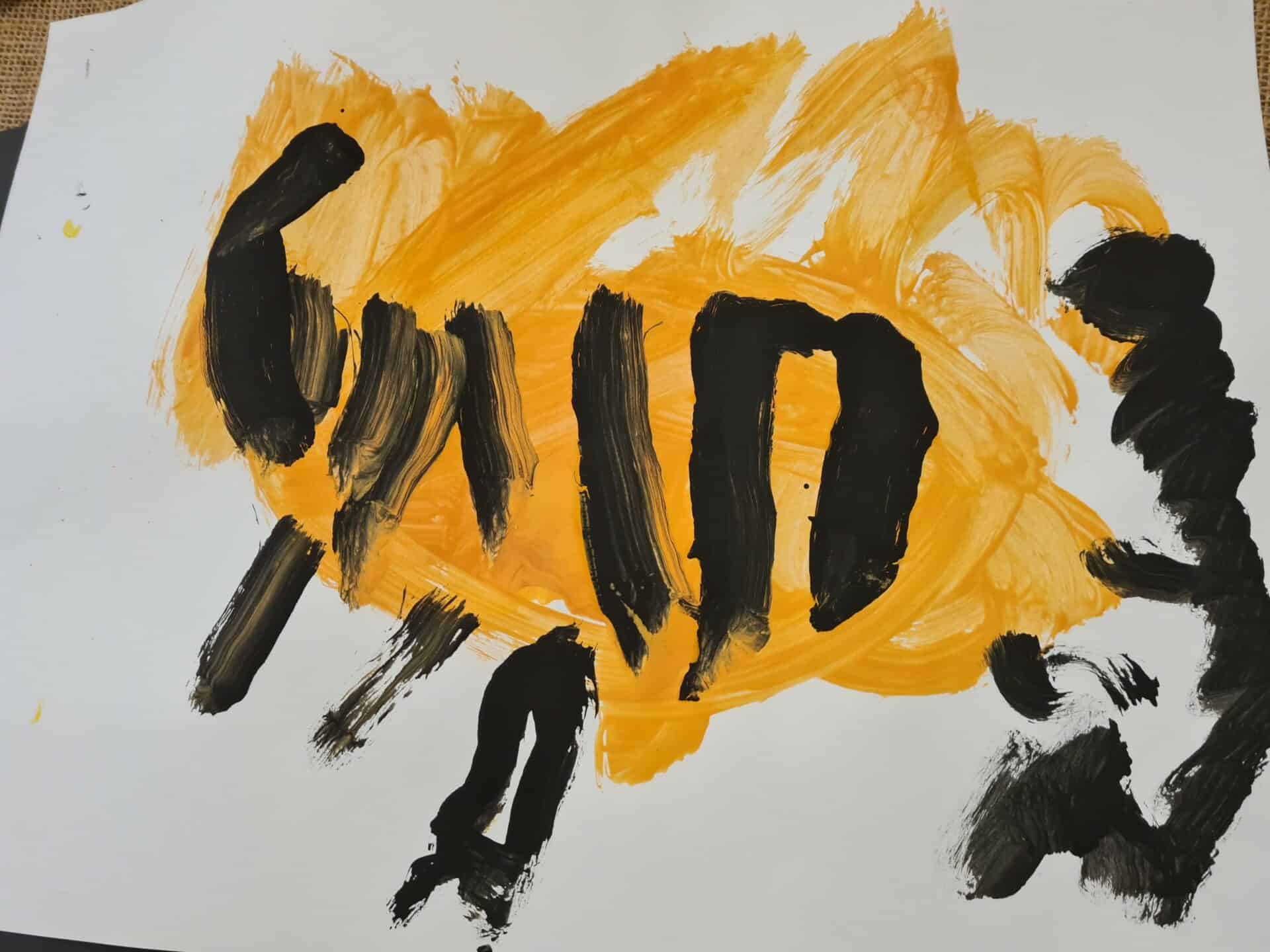 Bright children's artwork featuring bold black and yellow paint strokes, created by young artists at Thrive Childcare, showcasing creativity and early development skills.