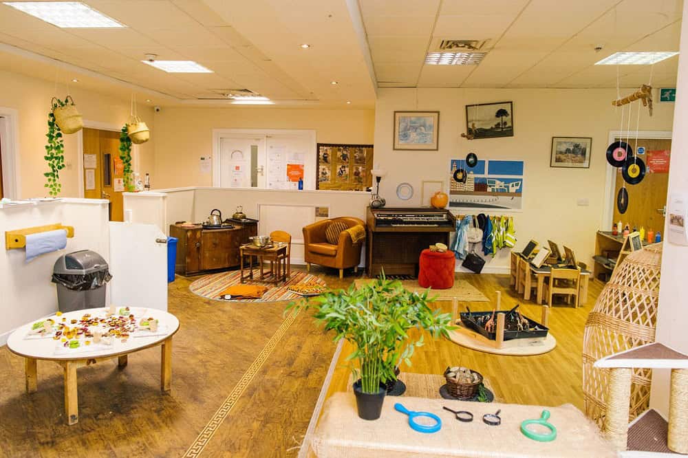 Brightly decorated indoor playroom at Thrive Childcare with musical instruments, art supplies, and comfortable seating, creating a fun and nurturing environment for children's learning and development.