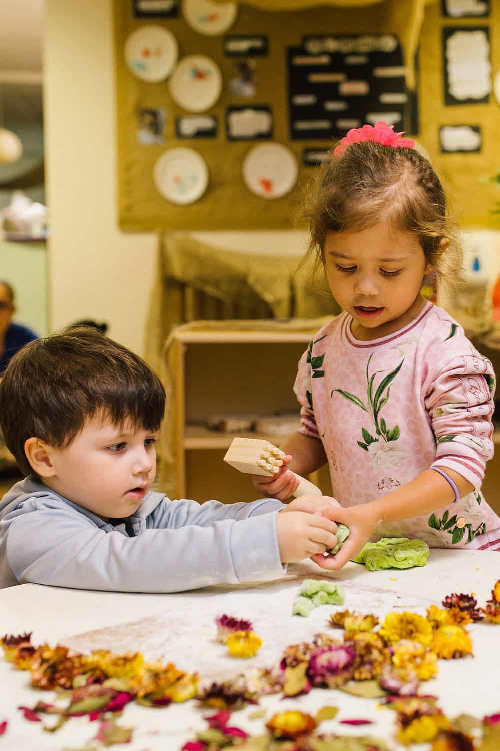 A caring young girl and boy engaging in creative play at Thrive Childcare, fostering early development and social skills in a nurturing environment.