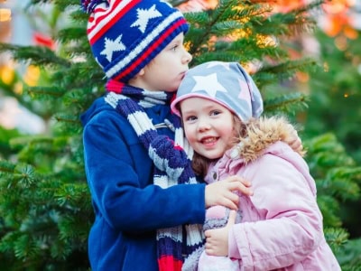 Happy children embracing outdoors in winter, dressed warmly, at Thrive Childcare, providing professional early childhood education and care in a safe, nurturing environment.