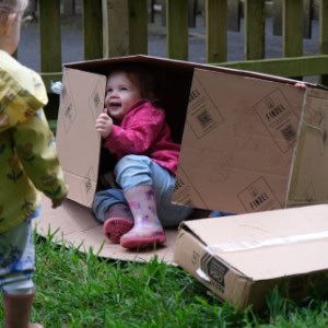 Children playing outdoors at Thrive Childcare, exploring and engaging in fun activities in a safe environment, promoting early childhood development and social skills.