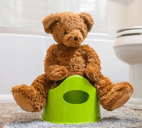 Soft teddy bear sitting on a green potty training seat, symbolising early childhood development and potty training at Thrive Childcare.