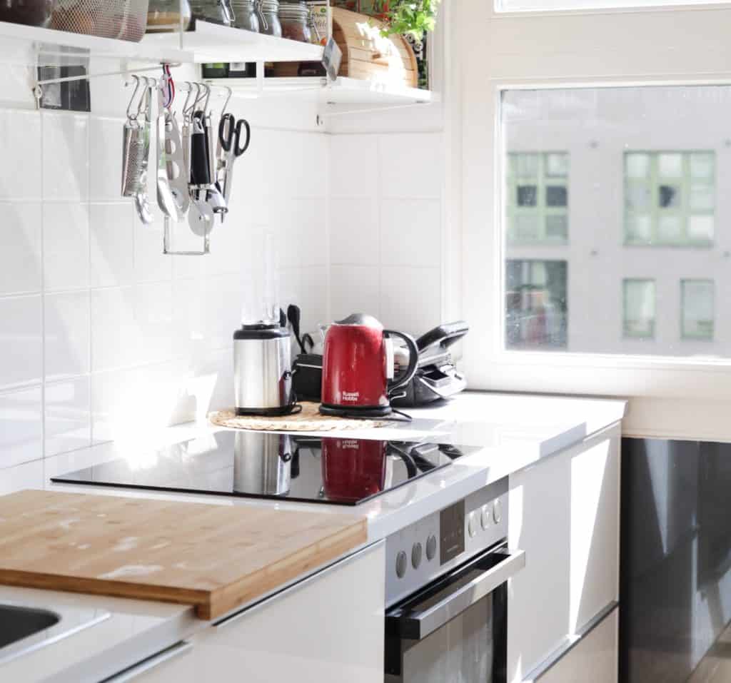 beazy-i3NR1cnwqUo-unsplash - Upstairs Downstairs Cleaning Service kitchen counter with stove and red kettle