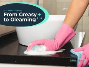 Kitchen cleaning with pink glove removing soap from countertop.