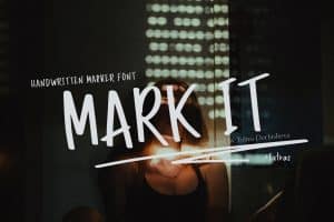 Handwritten marker font logo for 'MARK IT' with city lights background.