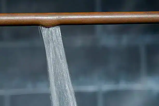 Burst pipe causing water leak in plumbing system.