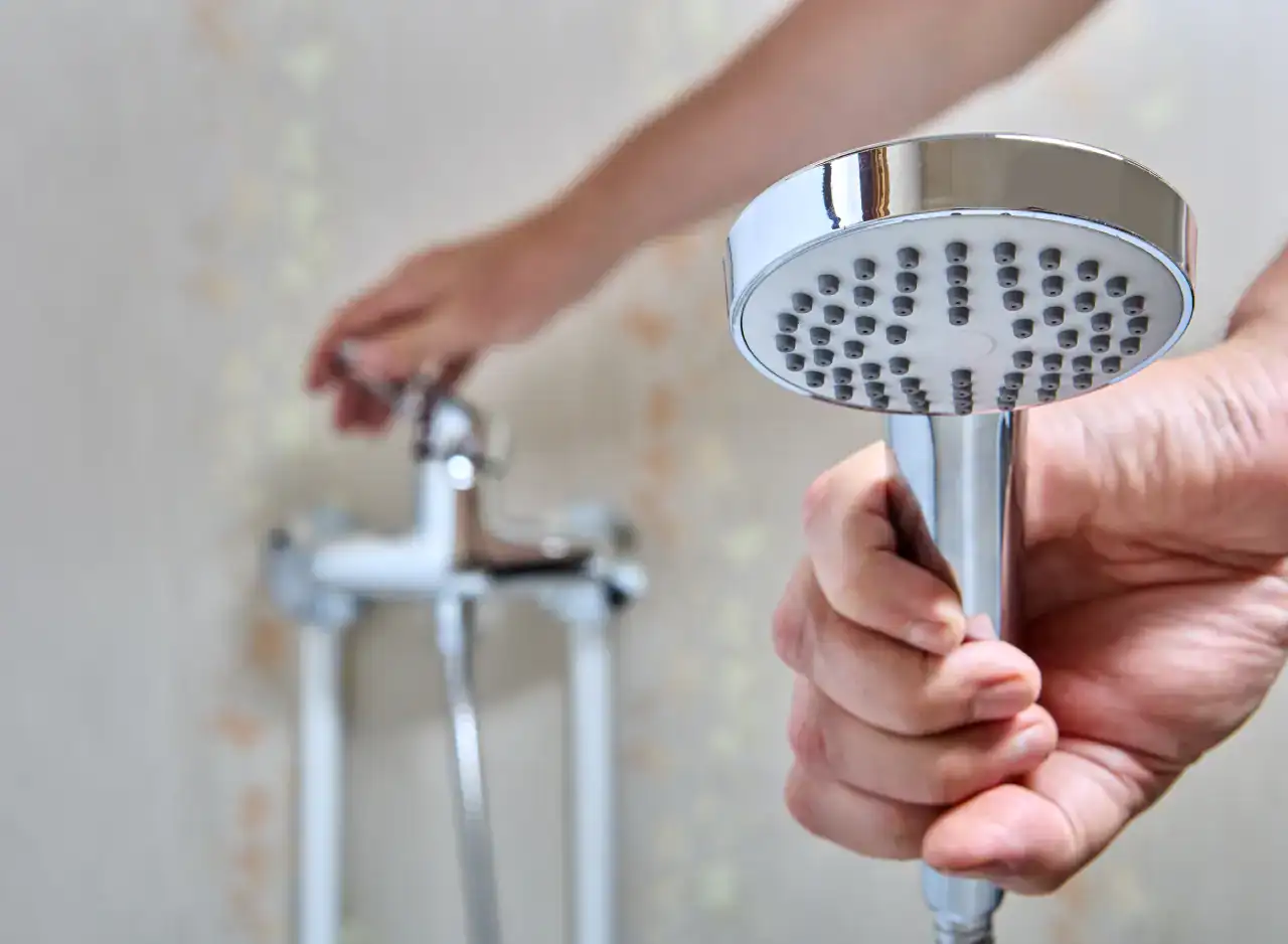 Bathroom shower head with repair focus, plumbing work in progress.