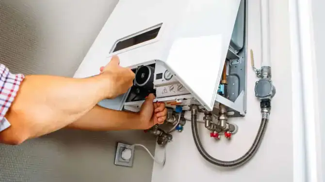 Technician repairing hot water system in a Richmond property for reliable plumbing.