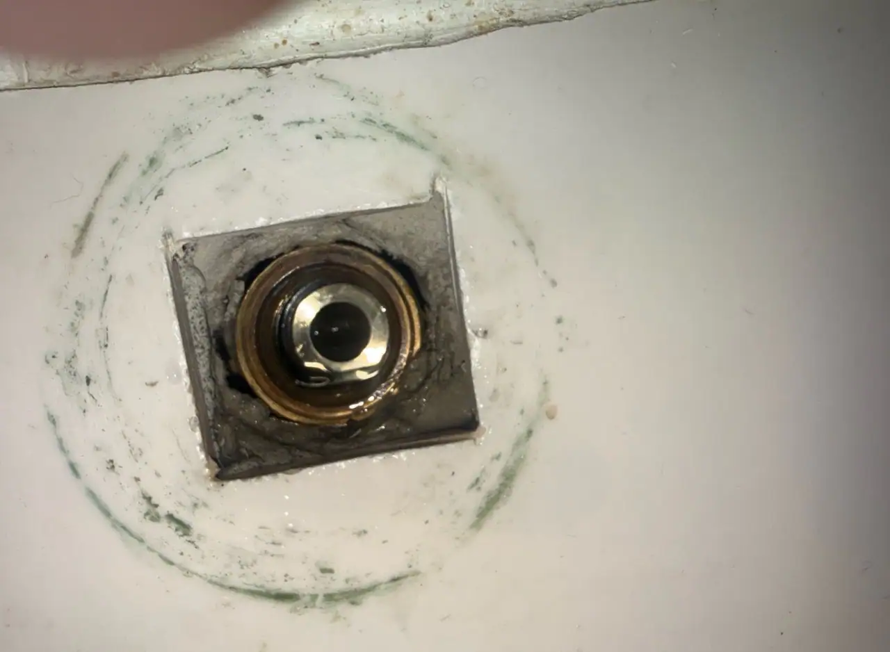 Bathroom sink drain pipe installation in progress.