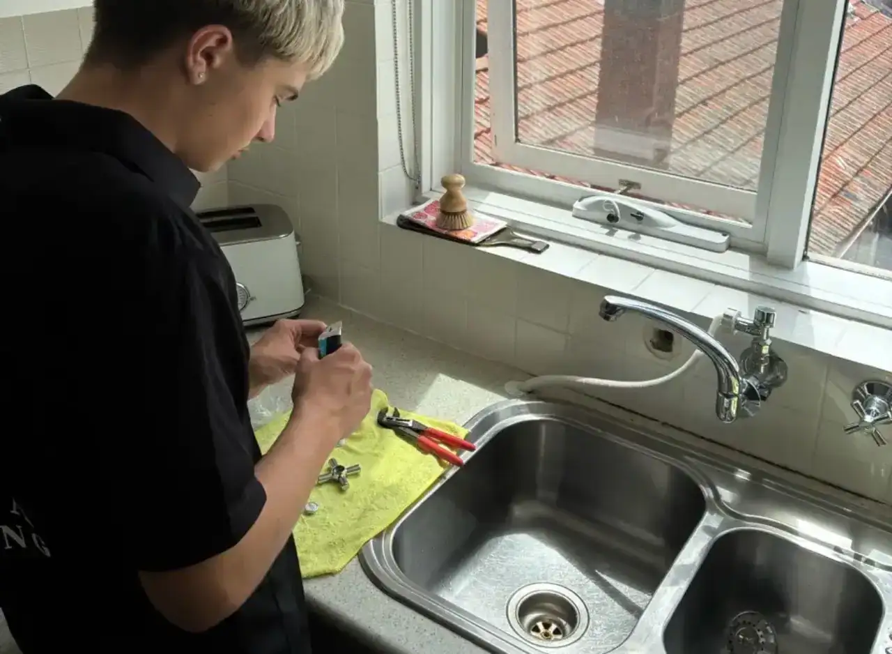 Plumber replacing tap component in Prahran home for reliable water flow.