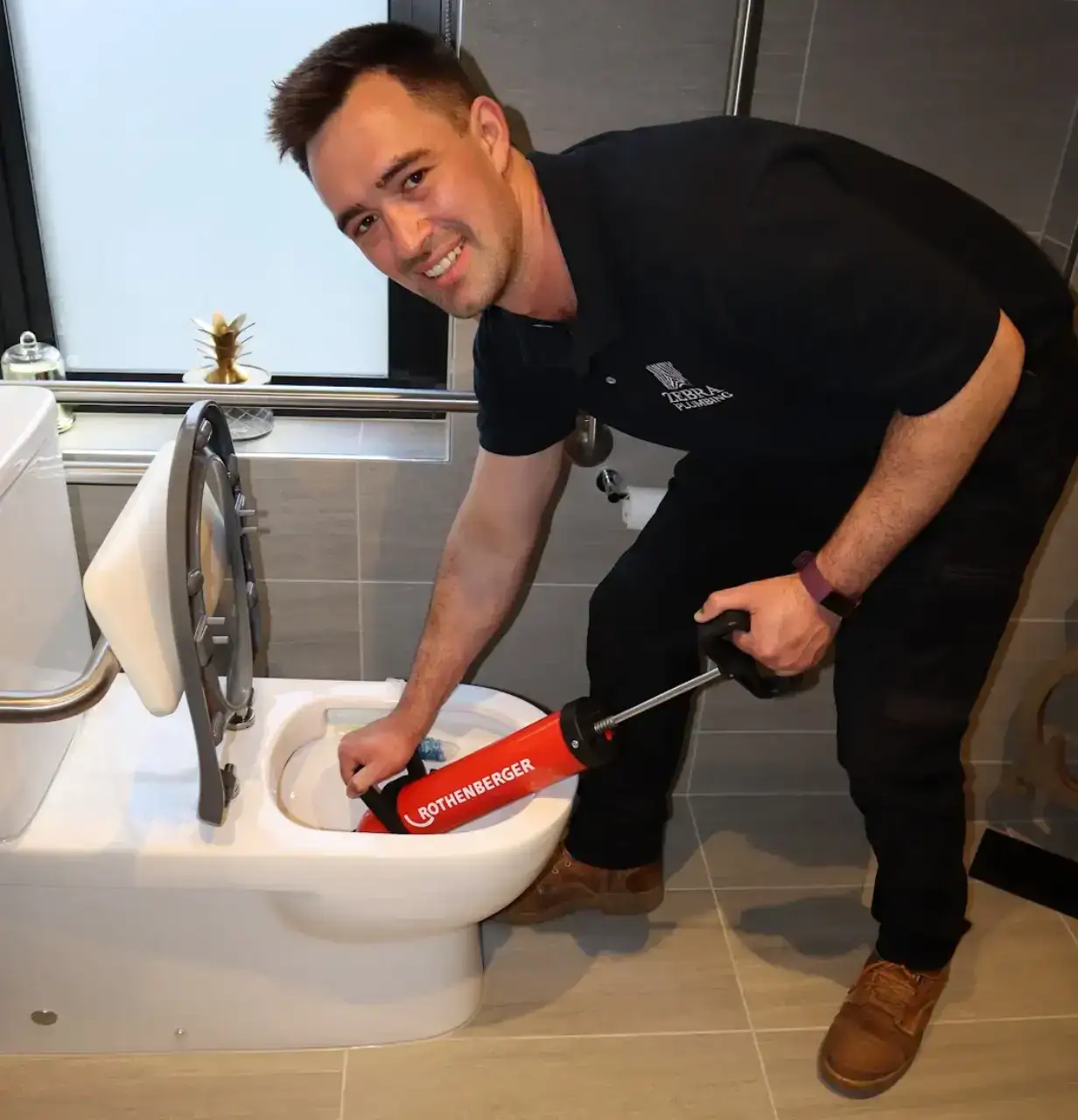 Zebra Plumbing emergency plumber repairing a leaking toilet in an Ivanhoe home during a late-night service call.