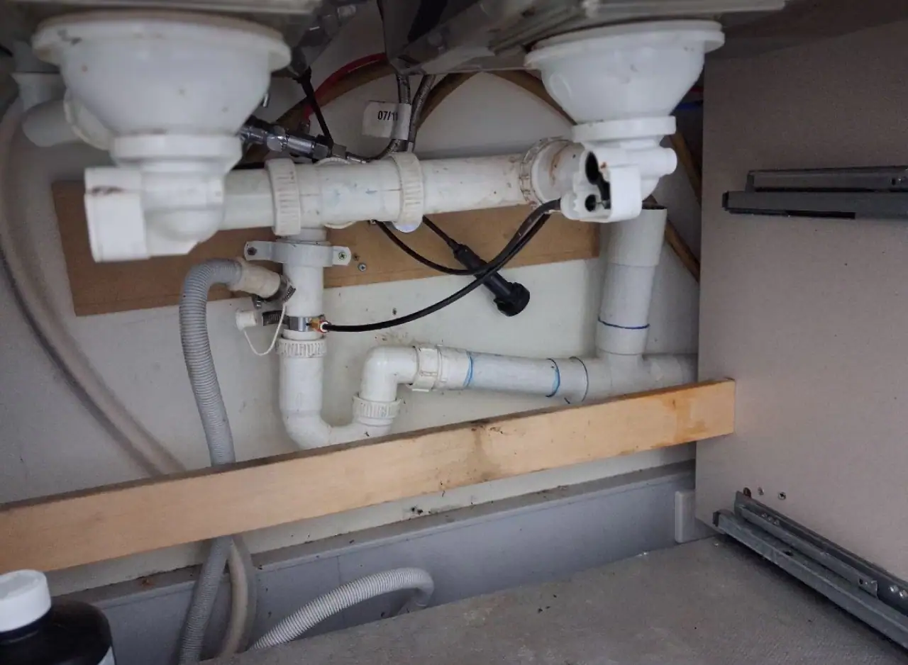 Under-sink plumbing pipes and fittings for kitchen or bathroom.