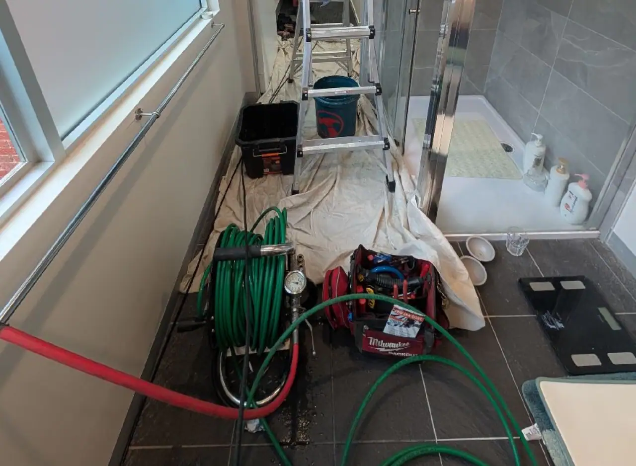 Emergency plumbing repair for water leak in bathroom.