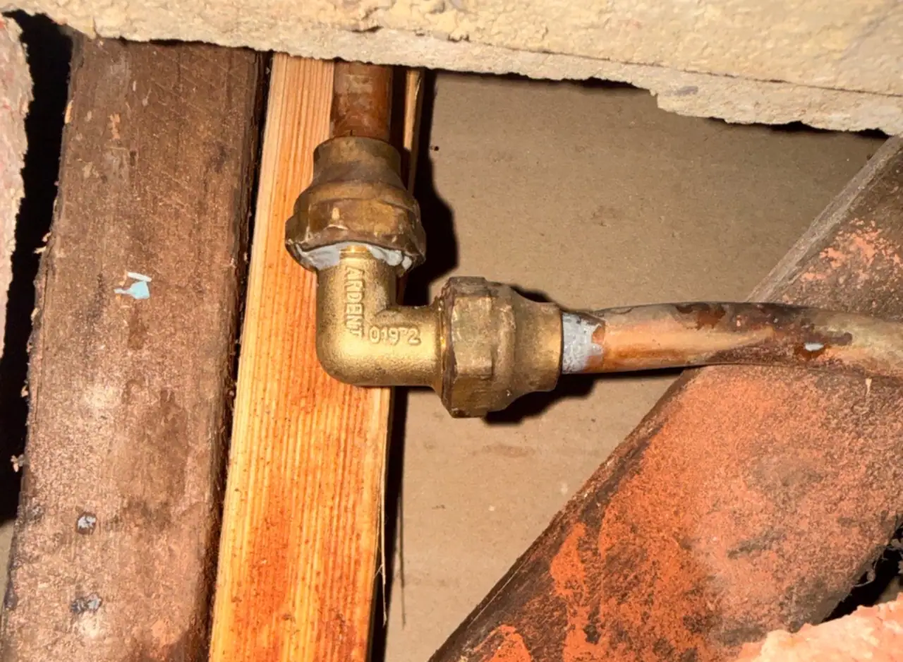 Close-up of a pipe fitting repair in a wall cavity in Richmond.