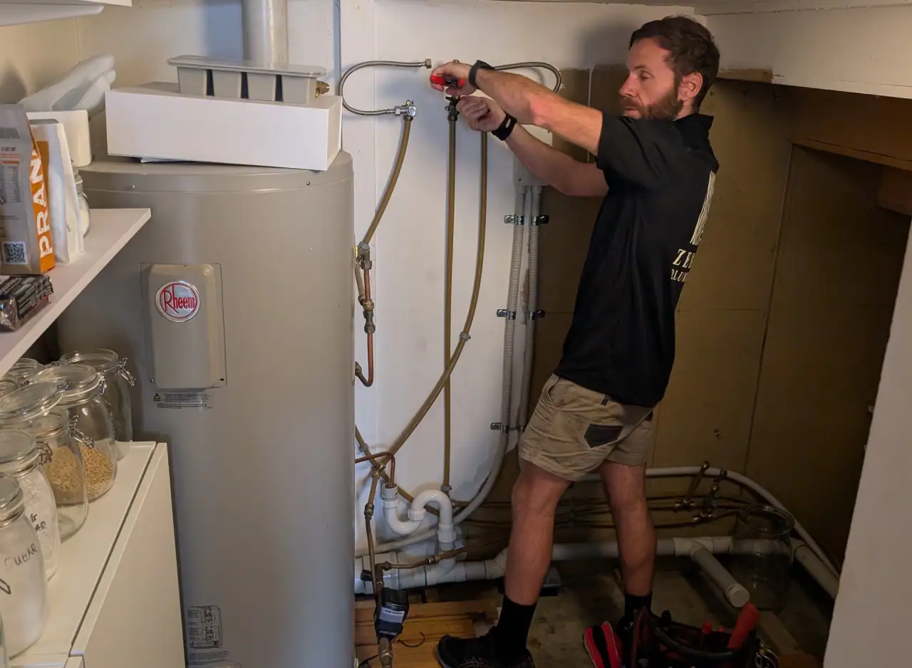 Technician installing a gas hot water system in Richmond.