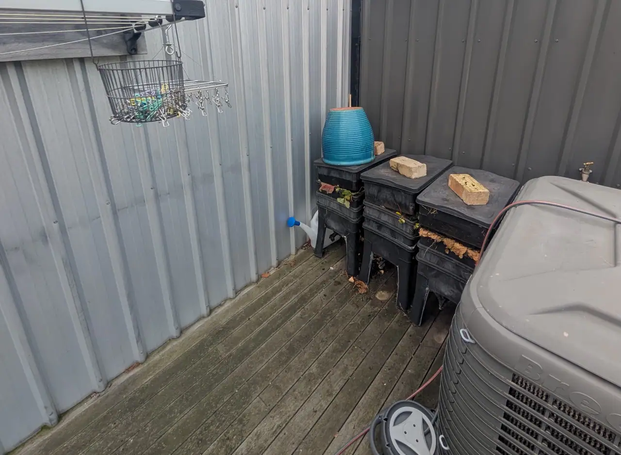 Gas hot water system installed outdoors in Richmond with storage tanks and piping.