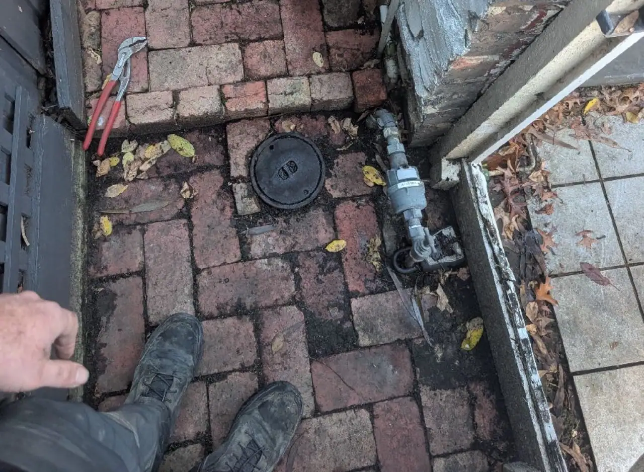 Drain inspection with access cover and plumbing pipe in Hawthorn.