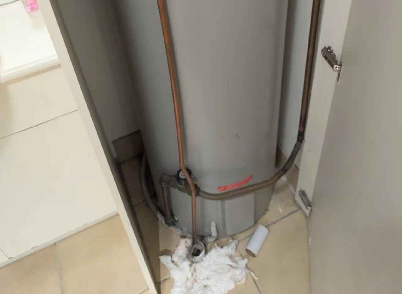 Hot water system repair with exposed pipes in Carlton property.