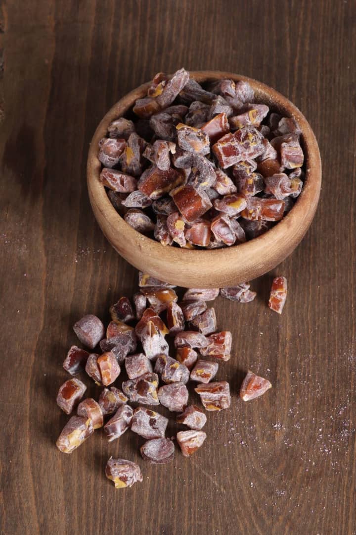 Chocolate flavored chopped dates in a wooden bowl