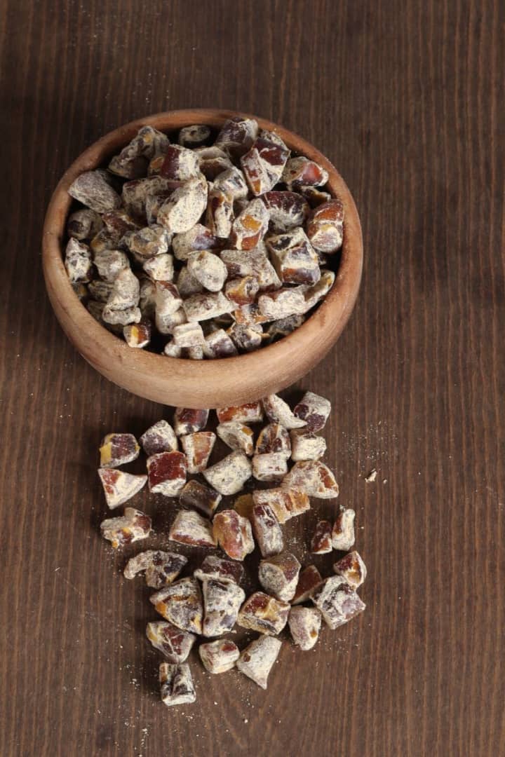 Ginger flavored chopped dates in a wooden bowl