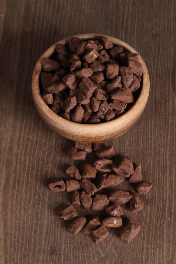 Cocoa coated chopped dates in a wooden bowl