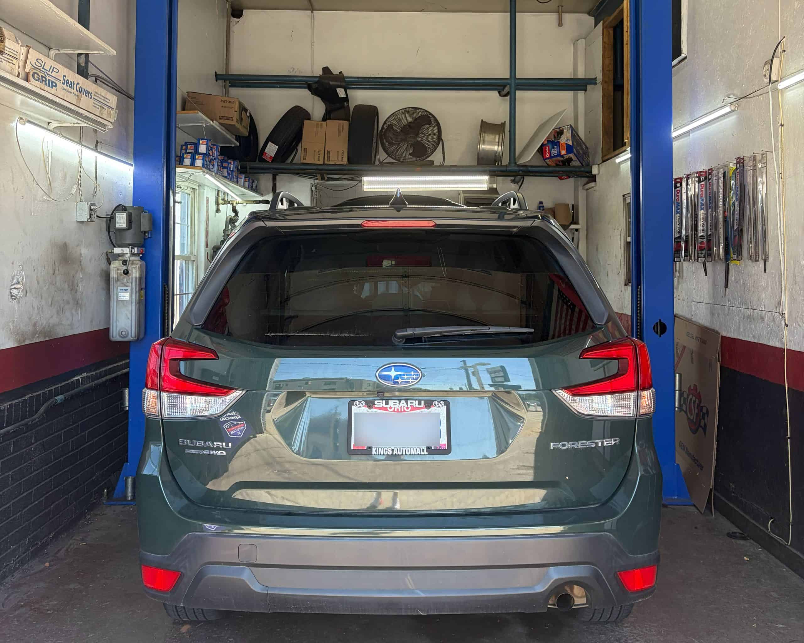 Subaru Outback vehicle in auto repair shop at Allen's QAC.