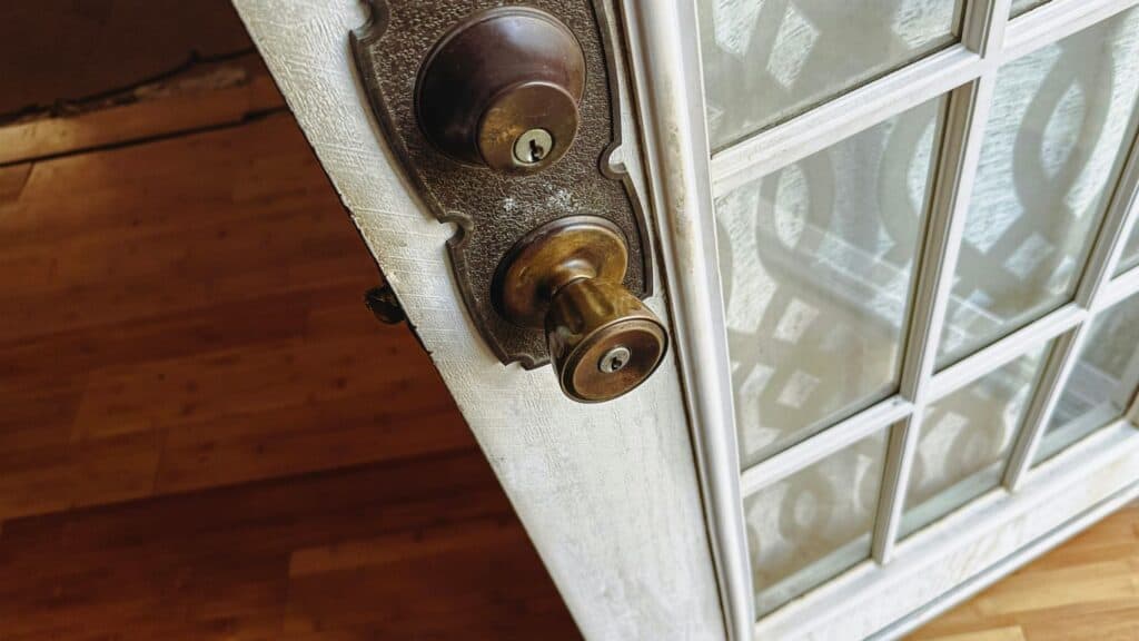 a close up of a door handle on a glass door
