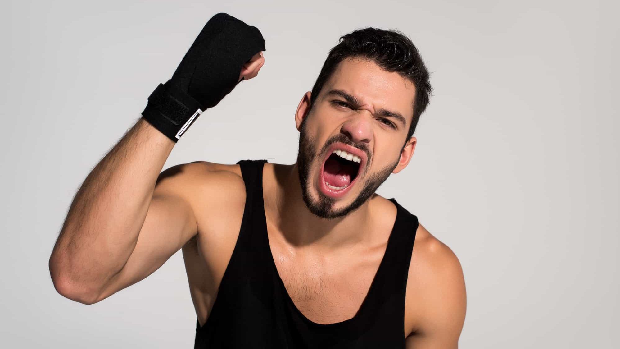 Angry young fighter screaming at camera