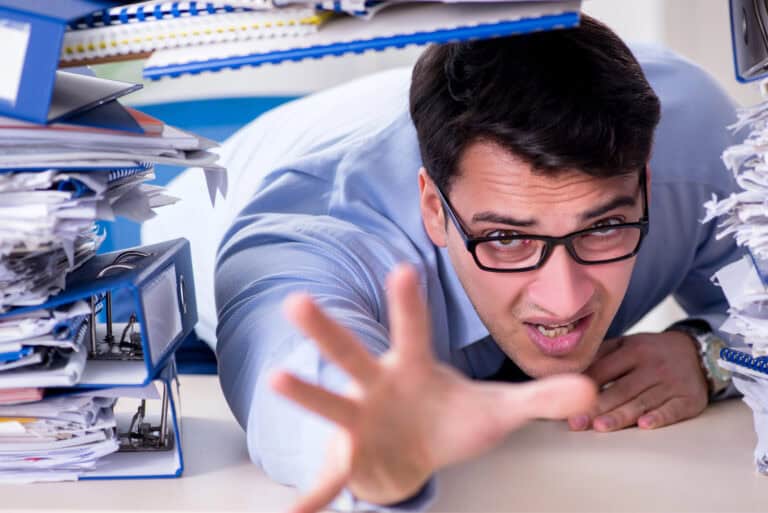 Extremely busy businessman working in office