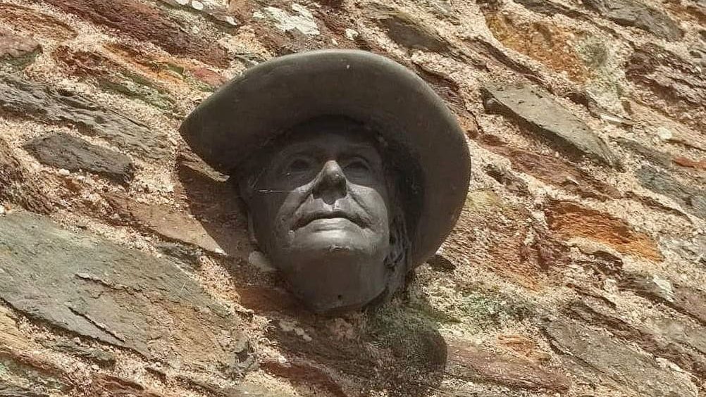 Statue head of Mary Wesley in a brick wall