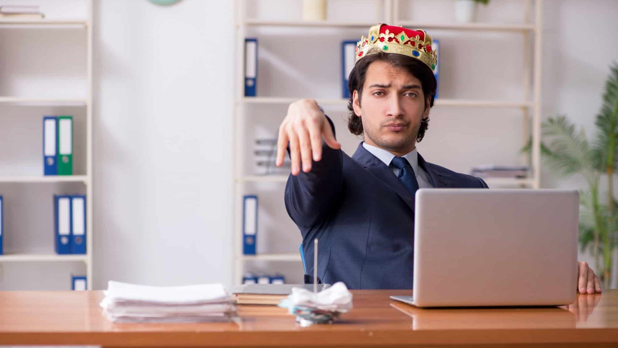 Young king businessman working in the office, arrogant