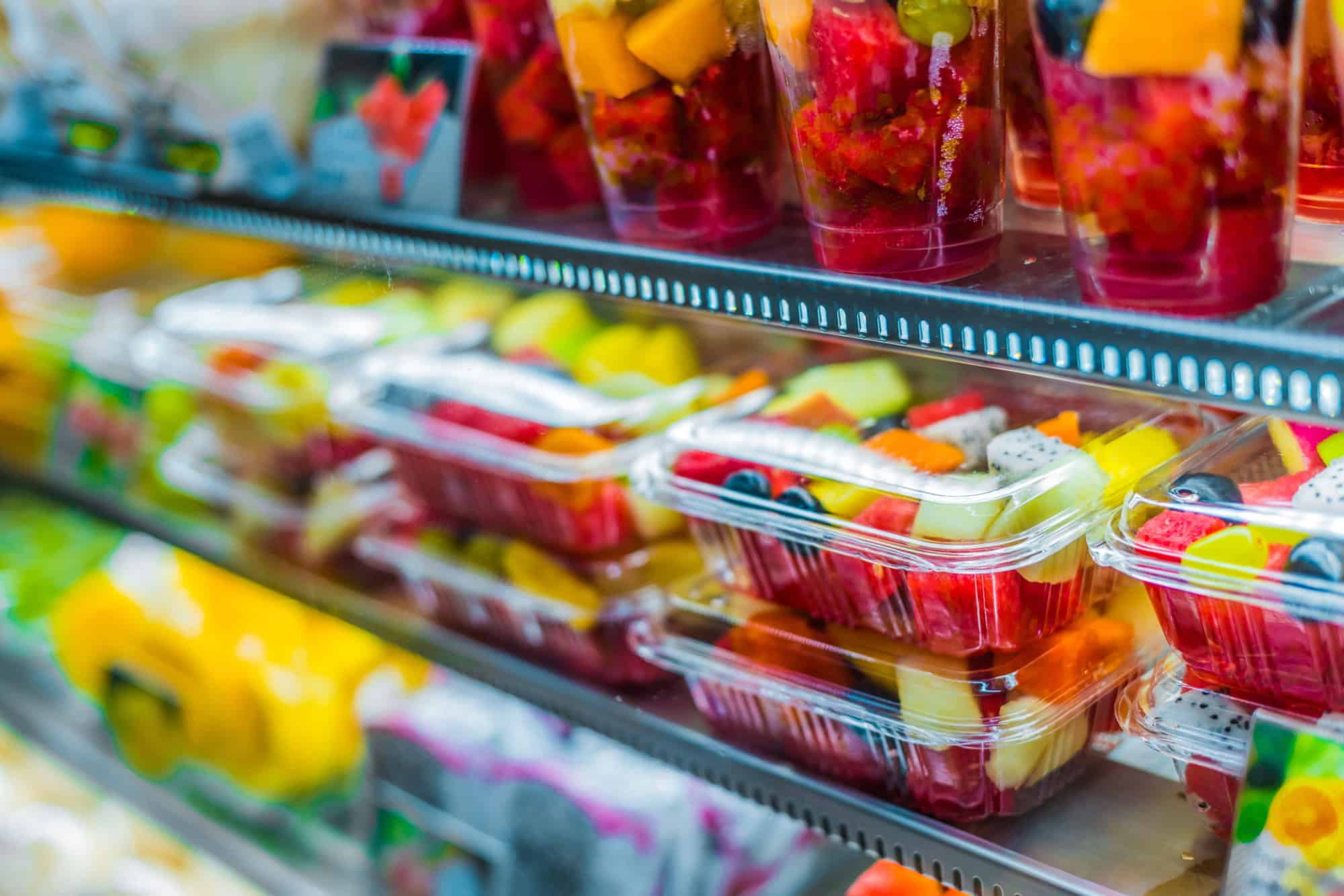Packages with fresh fruits displayed in a commercial refrigerator