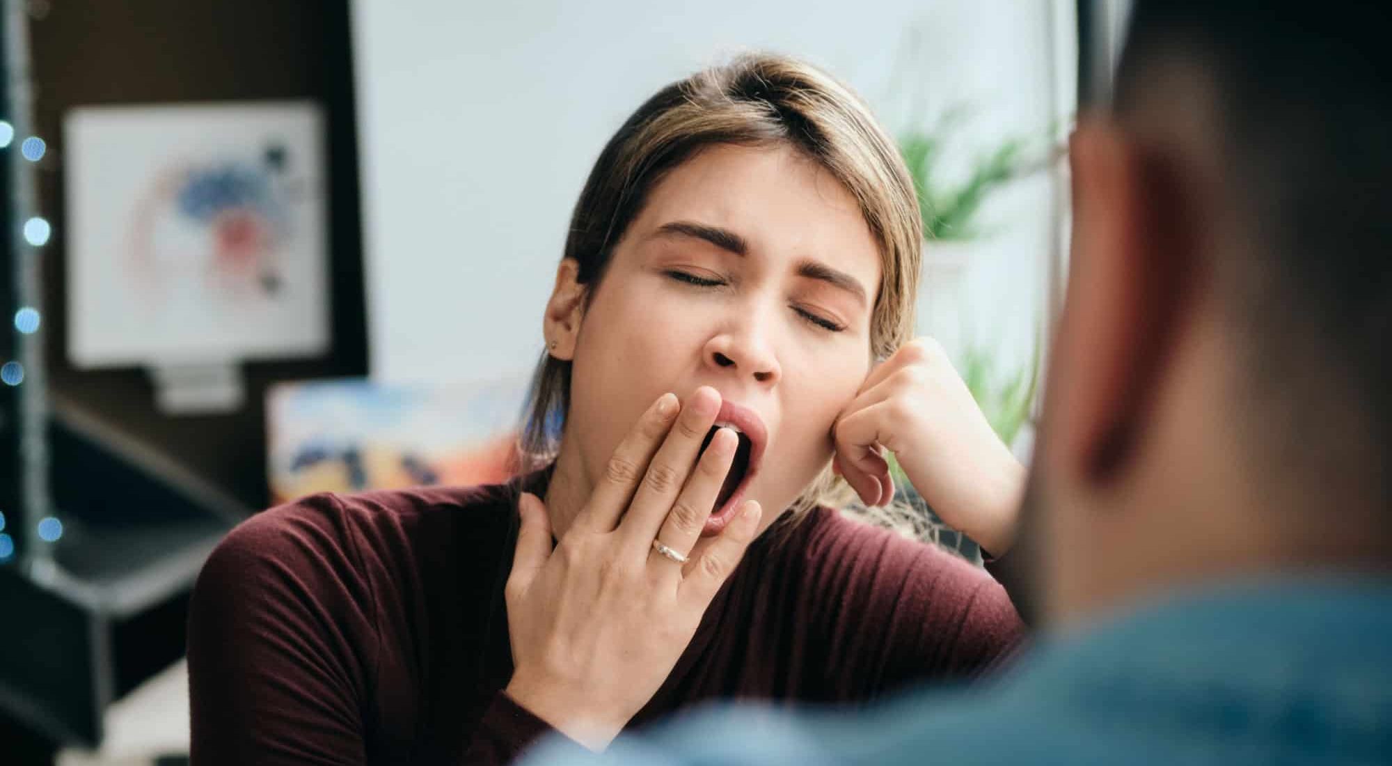 Woman Yawning During Boring Conversation With Partner