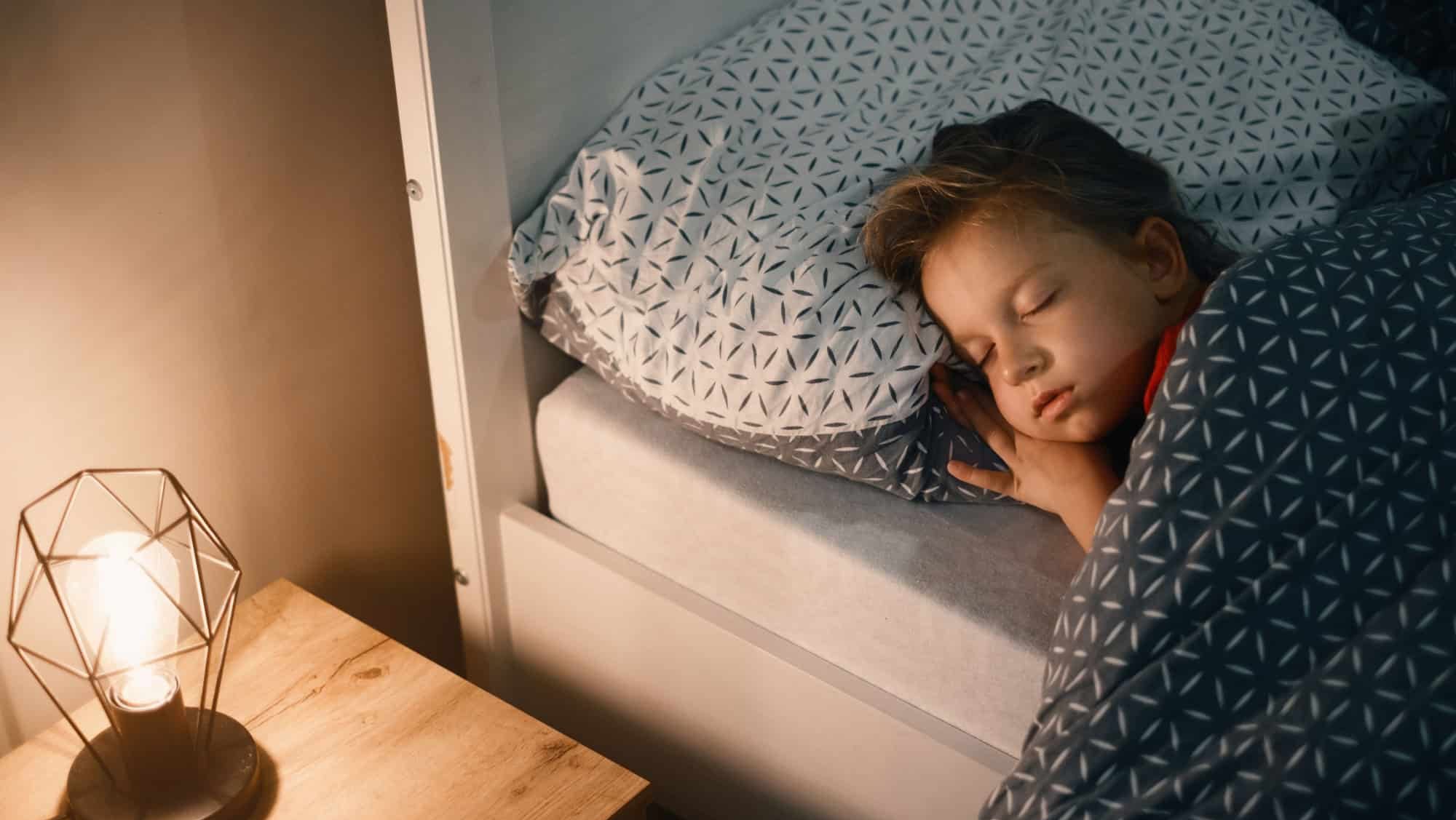Child sleeping at night. Comfortable bed for kids. Toddler girl sleeping tight, fast falling asleep, healthy habits and comfortable bedding