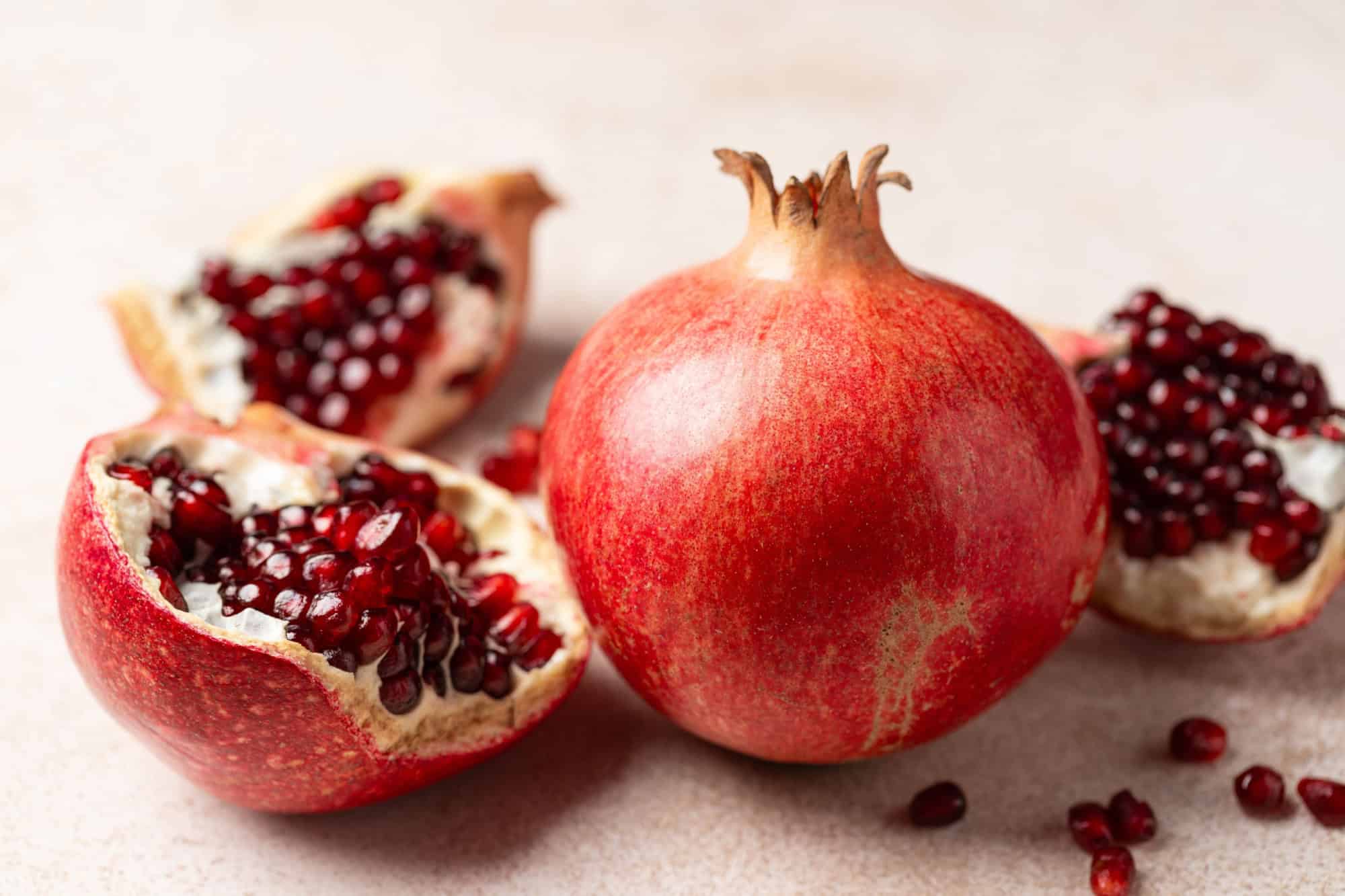 Pomegranate. Fresh organic juicy pomegranate fruit pieces. Pomegranate seeds, grains.