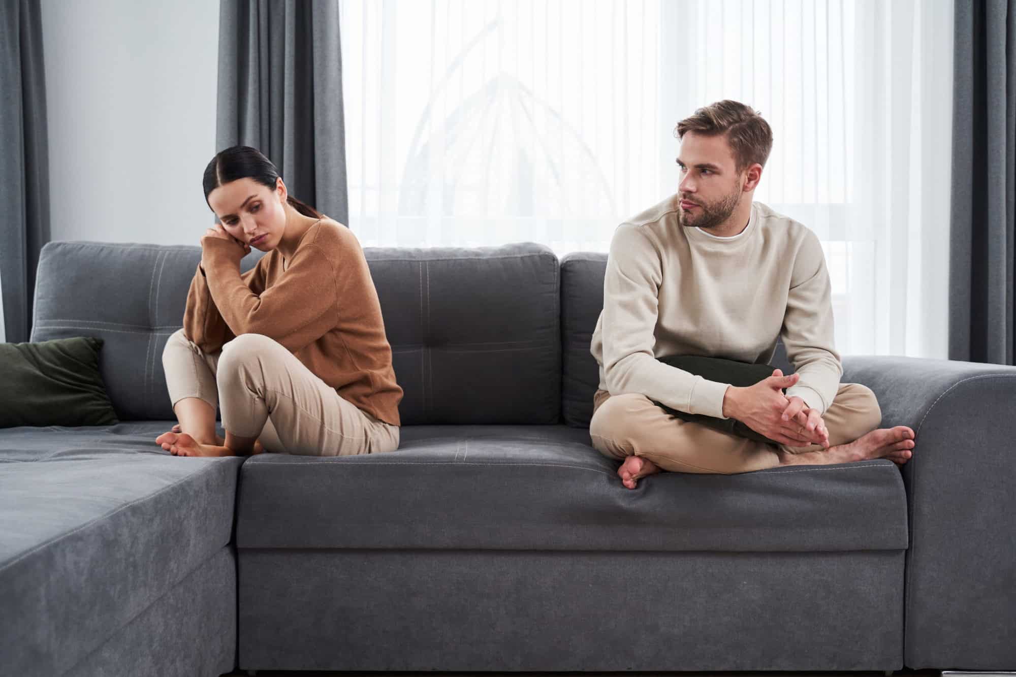 I can't believe we're still fighting about this. I can't believe he said that. Unhappy couple having argument at home. People, relationship difficulties, conflict and family concept