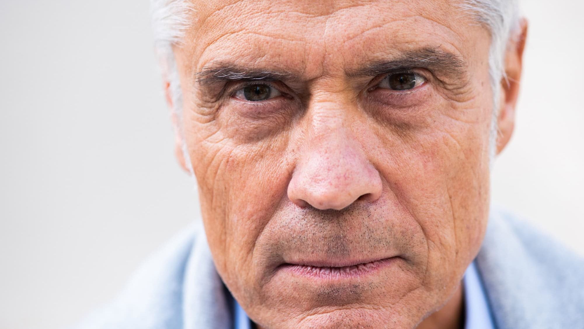 Close up portrait older man head with eyes staring