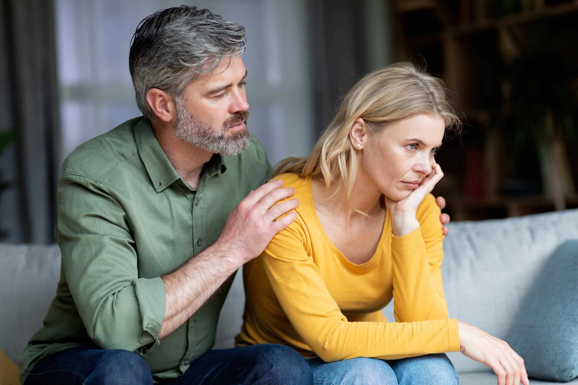 Loving Middle Aged Husband Comforting His Upset Offended Wife At Home, Worried Man Apologizing After Quarrel, Supporting Sad Souse, Mature Couple Suffering Relationship Crisis, Closeup Shot