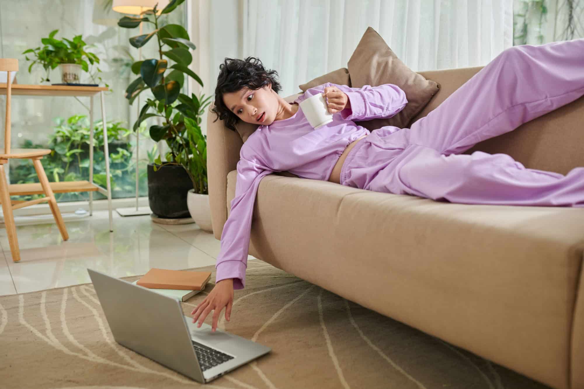 Lazy girl spending day relaxing on couch and wearing loungewear
