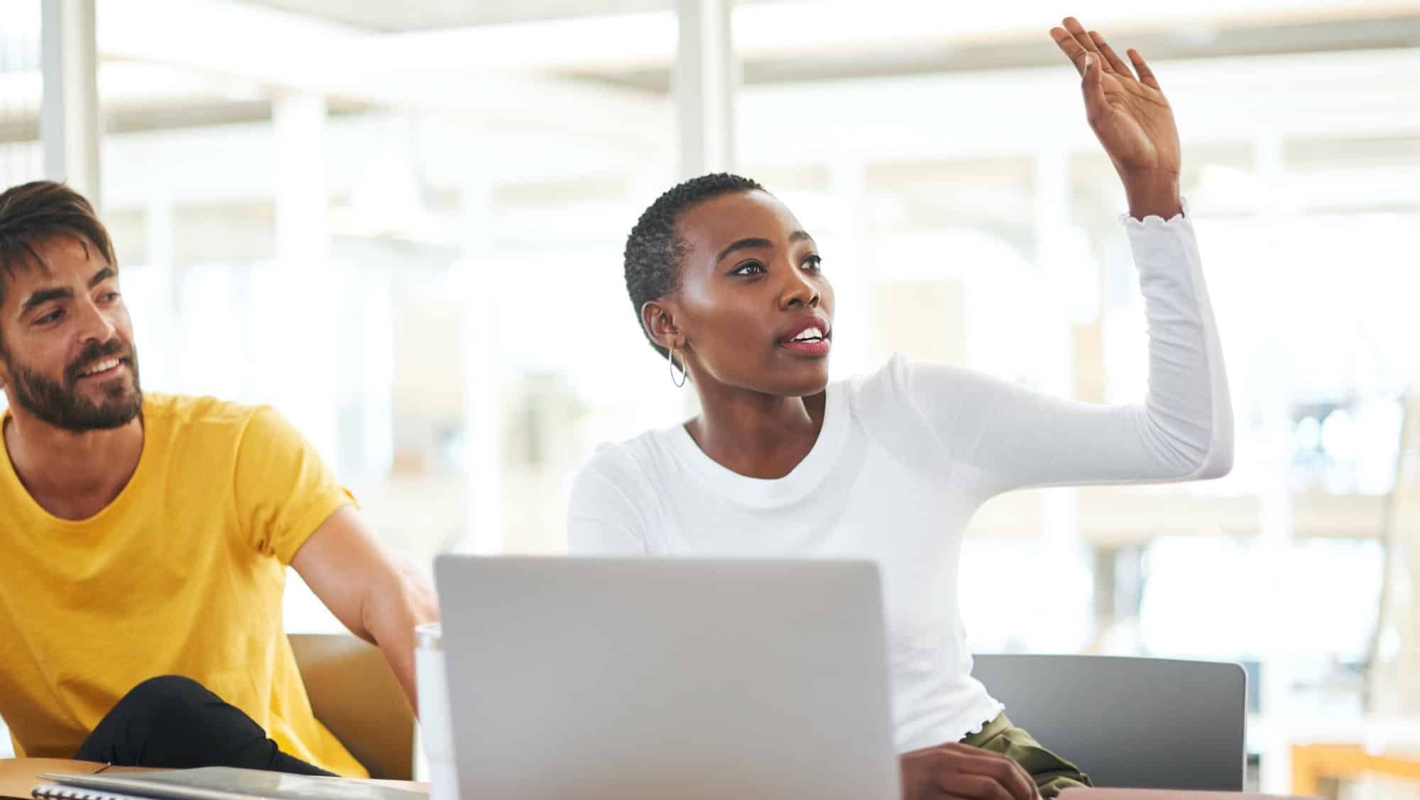 Ask more questions, gain more clarity. Shot of a young businesswoman raising her hand to ask a question during a meeting in a modern office.