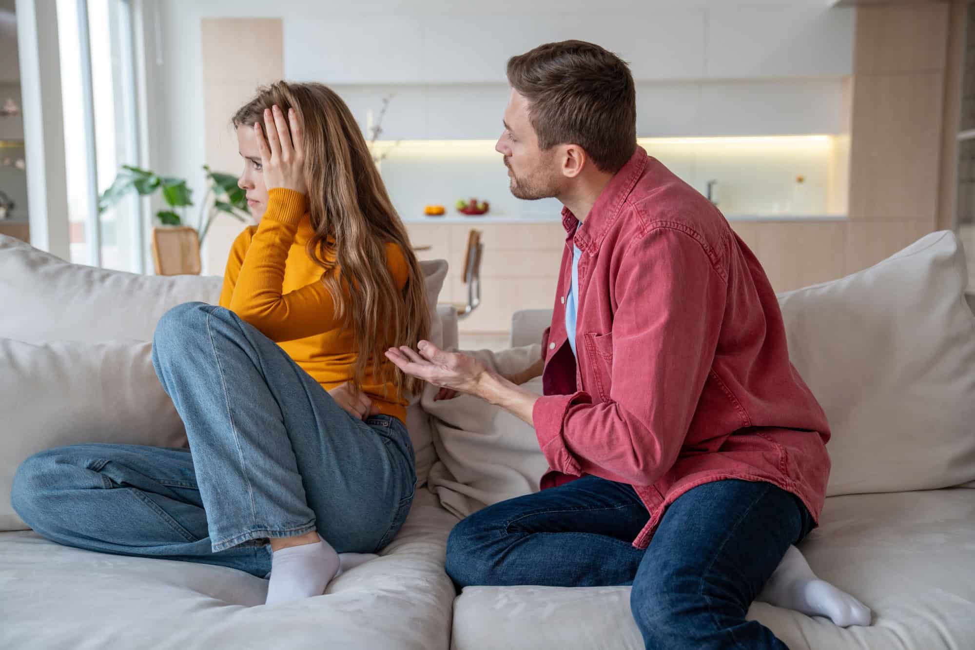Displeased woman manipulator ignoring husband wanting to talk. Frustrated wife abuser creates toxic atmosphere in family couple. Domestic emotional stress, misunderstanding, relationship problems.