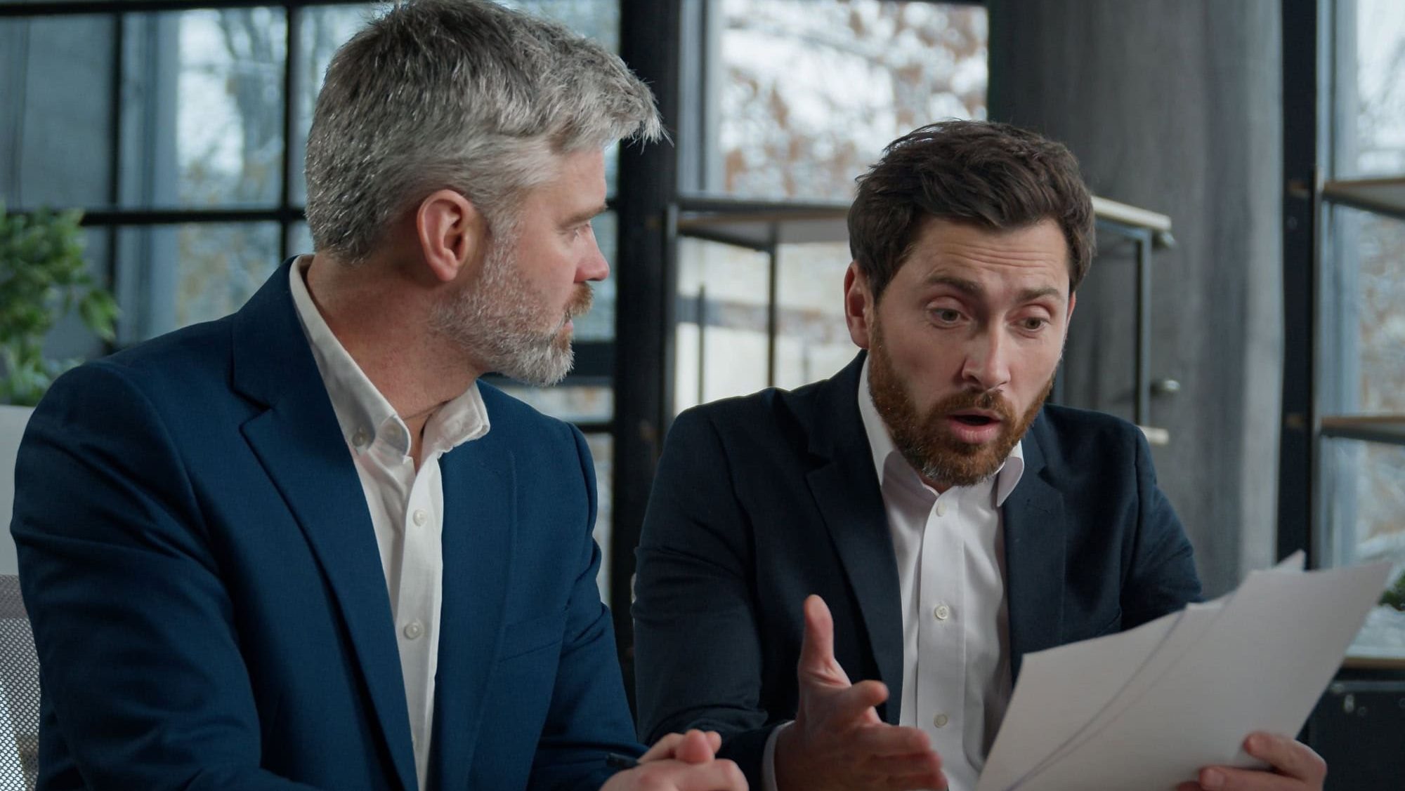 Nervous angry man boss argue scolds employee because mistake in documents financial papers Caucasian men businessmen arguing in office meeting business conflict problem mistake work failure bad result